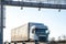 Truck drive through the highway through the toll gate, toll charges, blurred motion in the image