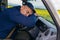 Truck driver falling asleep on steering wheel. Tiredness and sleeping concept