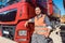 Truck driver in front of his freight forward lorry