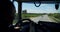 Truck driver View for Man driving car at country road on warm summer day. Slow motion