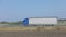 A truck drives on a road outside the city, a modern cargo truck drives on a highway