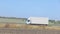 A truck drives on a road outside the city, a modern cargo truck drives on a highway