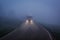 Truck driving at night on a narrow road