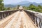 Truck driving over wooden bridge, Laos