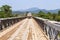 Truck driving over wooden bridge, Laos