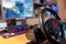 Truck driving simulator steering wheel on focus in front of a computer with glowing keyboard