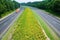 Truck driving on yellow flower lined state highway in rural Virginia