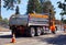 Truck dumper in urban traffic. A city in the USA. Roadworks