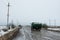 Truck on durty road with potholes and puddles