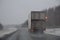 A Truck on highway in poor winter weather