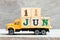 Truck hold block in word 11jun on wood background Concept for date 11 month June