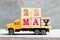 Truck hold block in word 22may on wood background Concept for date 22 month May