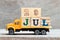 Truck hold block in word 29jul on wood background Concept for date 29 month July