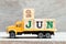 Truck hold block in word 2jun on wood background Concept for date 2 month June