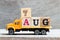 Truck hold block in word 7aug on wood background Concept for date 7 month August