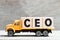 Truck hold block in word CEO Abbreviation of Chief Executive Officer on wood background