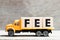 Truck hold block in word fee on wood background