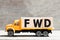 Truck hold block in word FWD Abbreviation of forward on wood background