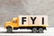 Truck hold block in word FYI Abbreviation of For your information on wood background