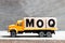 Truck hold block in word MOQ Abbreviation of Minimum Order Quantity on wood background