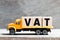 Truck hold block in word VAT Abberviation of Value added tax on wood background