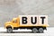 Truck hold block in word but on wood background