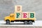 Truck hold letter block in word 5feb on wood background Concept for date 5 month February