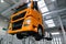 Truck on a lift in a car service. Service maintenance of trucks. The car is serviced in a large garage, diagnostics, repair,