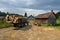 A truck loaded with logs and a cart in a mountain village in the Ukrainian Carpathians