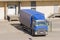 Truck loading goods, cargo, warehouse with doors.