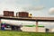 Truck with logs traveling at speed on a viaduct bridge