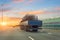 Truck with long trailer loaded with metal cylinder rebar frame for the construction of a building drives along the highway