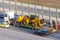 Truck with a long trailer platform for transporting heavy machinery, loaded tractor with a bucket. Highway transportation traffic