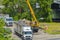 A truck with a mobile crane removes and loads a container