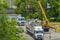 A truck with a mobile crane removes and loads a container with a temporary building