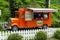 Truck mobile shop for drinks. A tea shop on wheels. Stylish orange truck