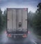 Truck moves in the rain on a country road