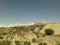 Truck passes over an overpass with clouds seeming to stream behind from train