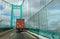 A truck pulling a cargo container drives over the Saint Thomas Bridge and over the Port of Los Angeles.