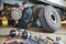 Truck repair service. Mechanic works with brakes in truck workshop