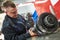 Truck repair service. serviceman works gear shaft of gearbox