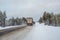 The truck rides on a snow-covered Arctic road
