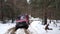 Truck rides on a snowy road in a forest in the mountains