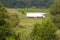 Truck rides way out in the field.