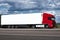 Truck on road with white blank container, blue sky, cargo transportation concept