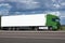 Truck on road with white blank container, blue sky, cargo transportation concept