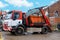 A truck self-loading industrial skip. Taking skip full of rubbish from construction site for recycling