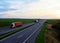 Truck with semi-trailer driving along highway on the sunset background. Goods delivery by roads. Services and Transport logistics