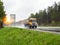 Truck with a semi-trailer grain carrier transports grain on the highway in rainy weather. Industry, copy space for text