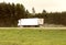 A truck with a semi-trailer transports cargo in summer in cloudy rainy weather on a wet road in the rain. Skidding on